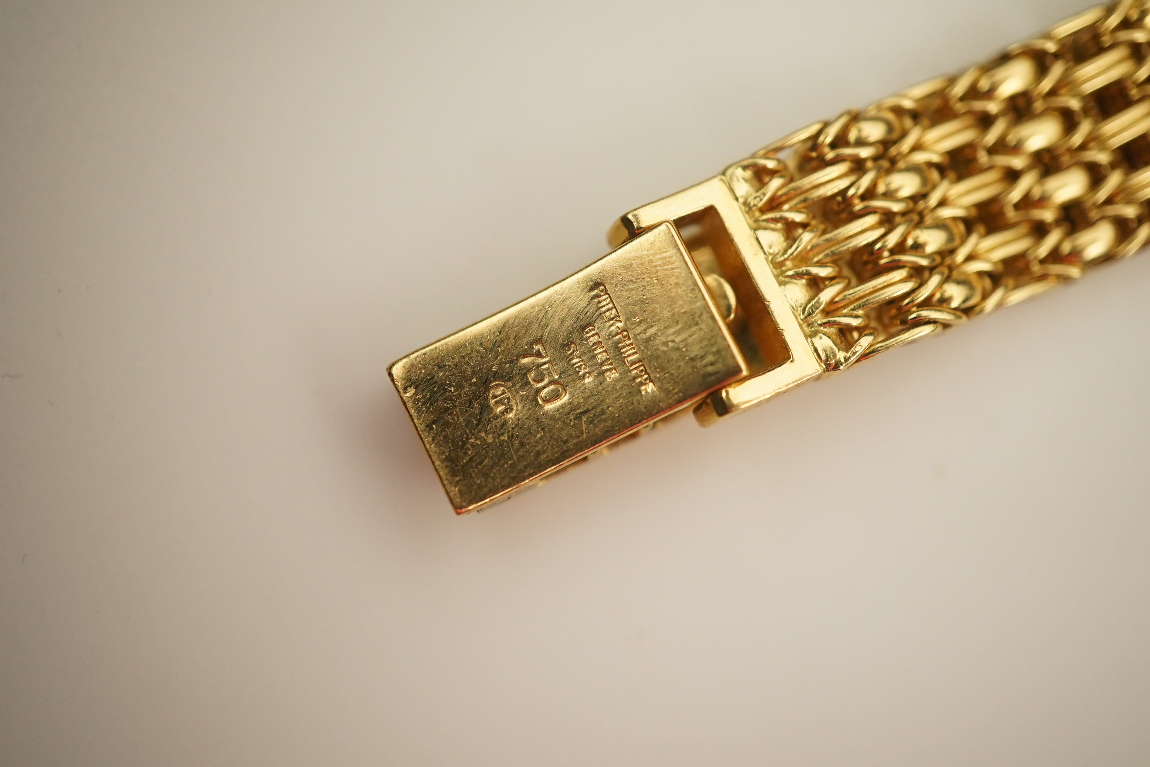 A lady's 18ct gold Patek Philippe manual wind wrist watch, on an integral 18ct gold Patek Philippe bracelet